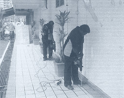 Helang Rampai technicians drilling a treatment line along a walkway